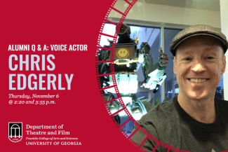 Smiling man with cap, standing in front of robot known as Pathfinder