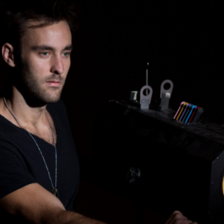 A Theatre and Film Studies student operates a performance lighting against a white background.